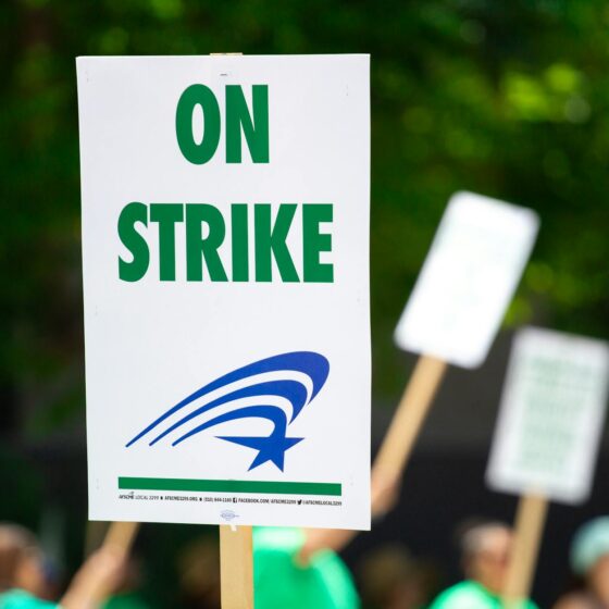 people rallying carrying on strike signage