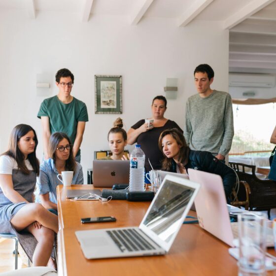 group of people watching on laptop