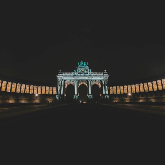 the dark night sky with a large arch in the background