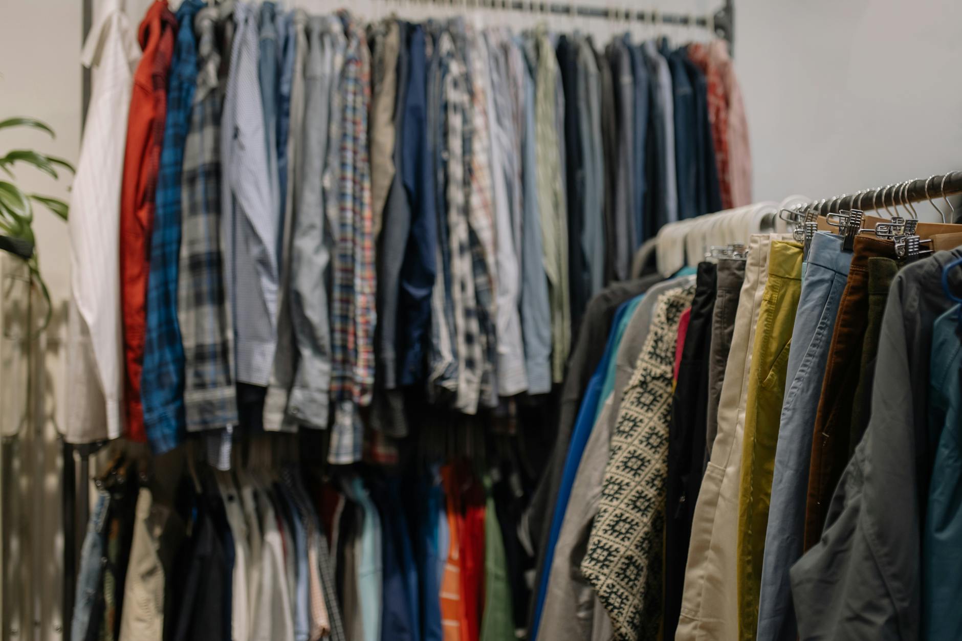 assorted clothes hanged on a clothes rack