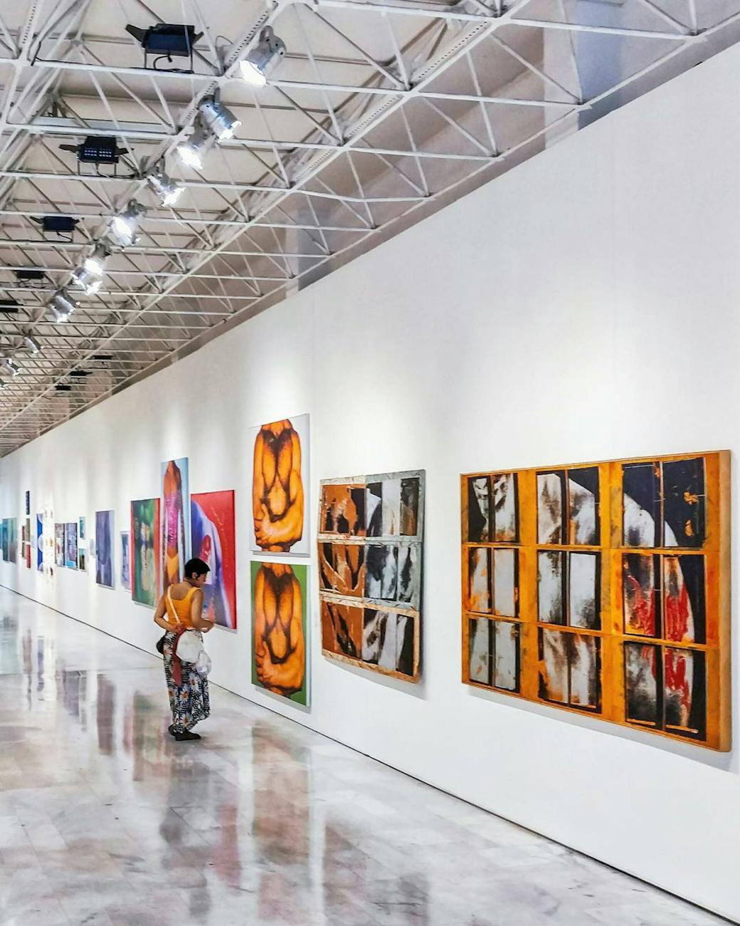 woman looking at paintings